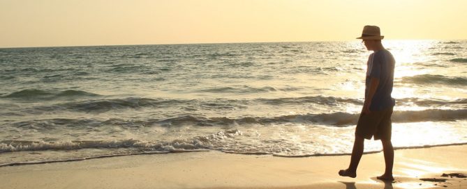 Man on beach after mental health counseling.